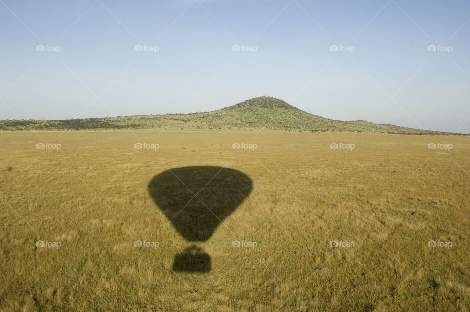 Shadow of hot-air balloon over the savanna in Tanzania Africa.