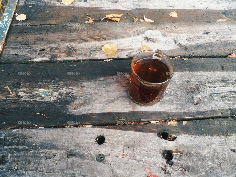 cup of black tea on an old wooden table