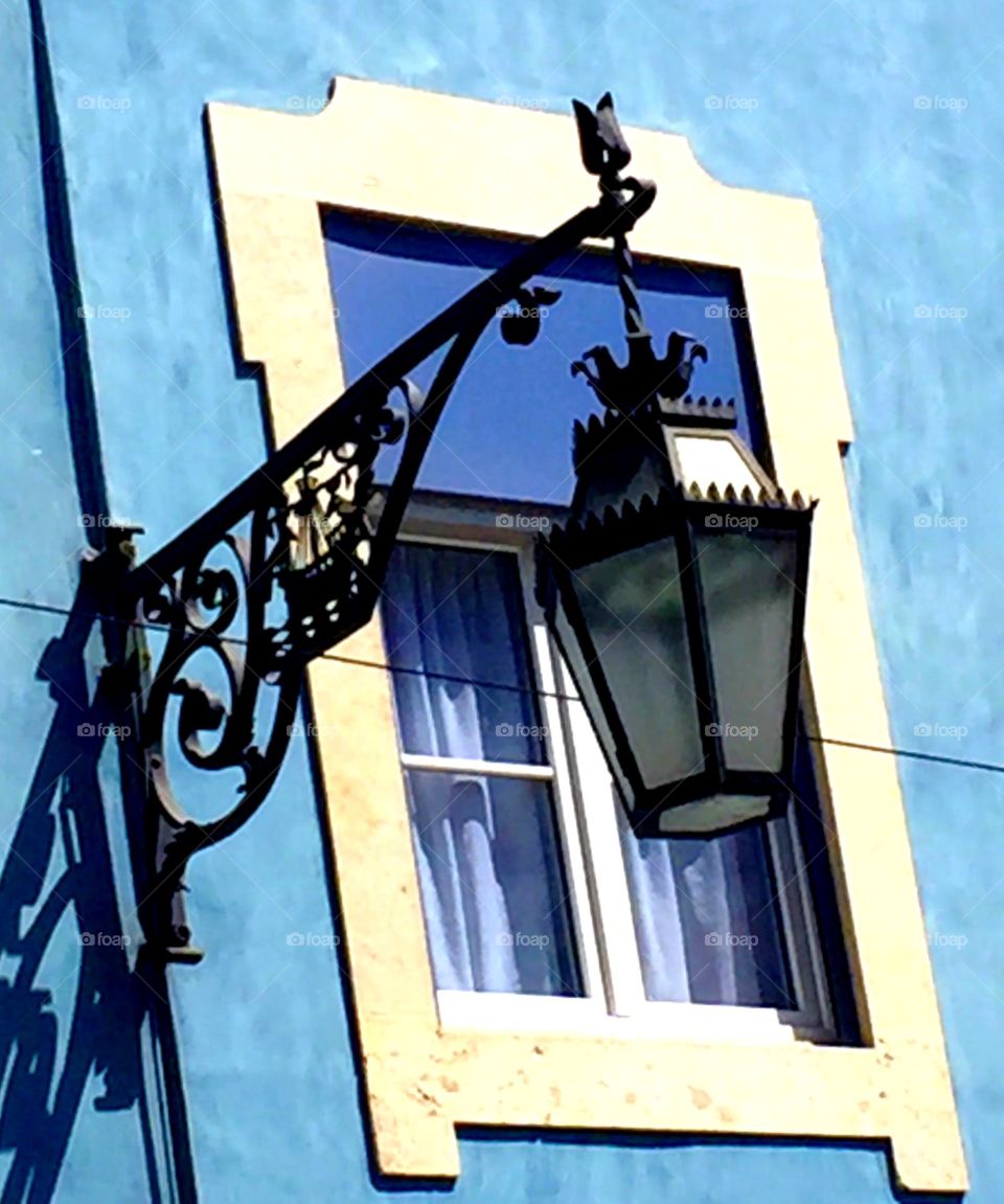 Street lights and blue building in the background 