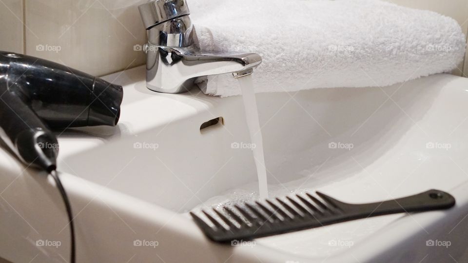 Comb and hair dryer on sink