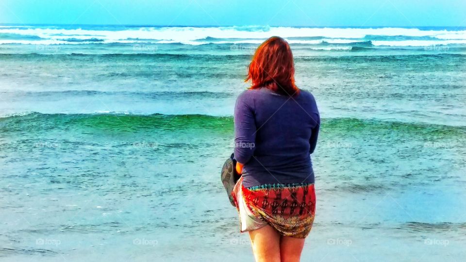 Red Head deep in thought staring across the ocean