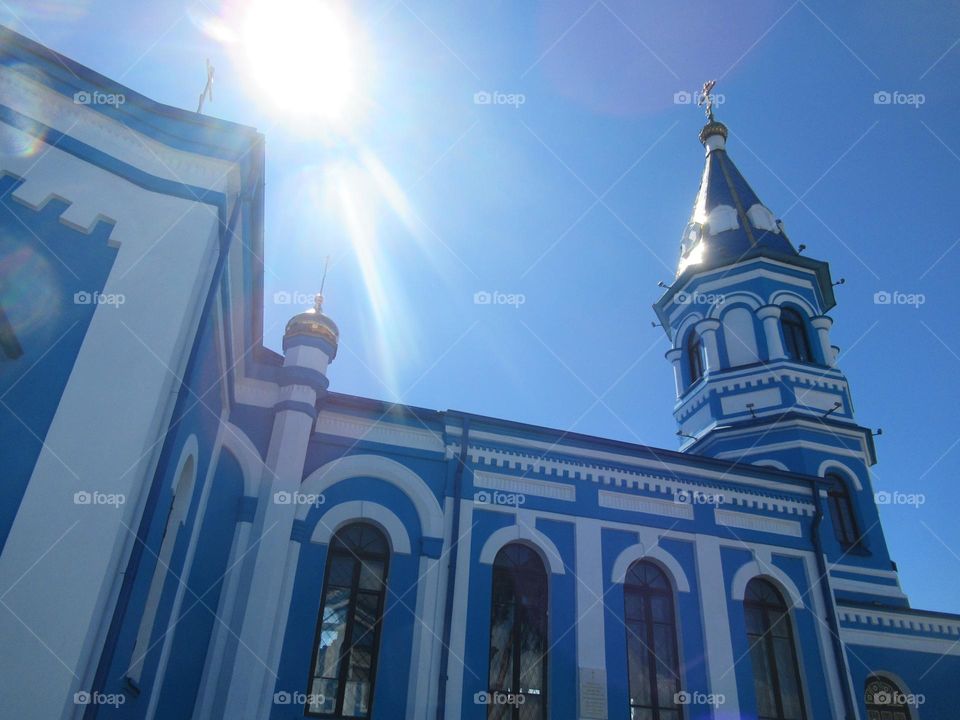 Orthodox church against the backdrop of blue sky and bright sun, Caucasus, Russia