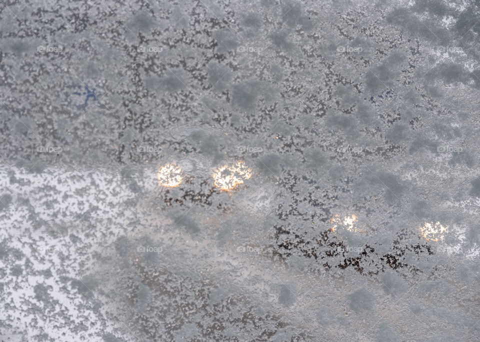 Headlights of two cars approaching down the road in reduced visibility due to a snowy window during a snow storm in Helsinki, Finland on 23 November 2017.