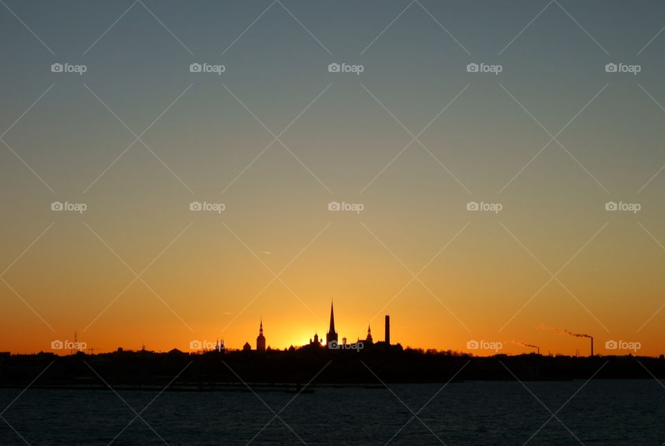 Skyline or silhouette of Tallinn, Estonia at sunset time on late December evening in 2015.