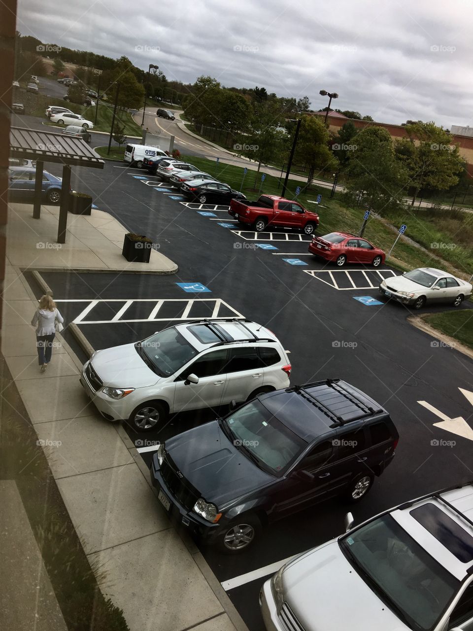 Parking lot at a Doctors Park.  Entrance is visible from my window vantage point.