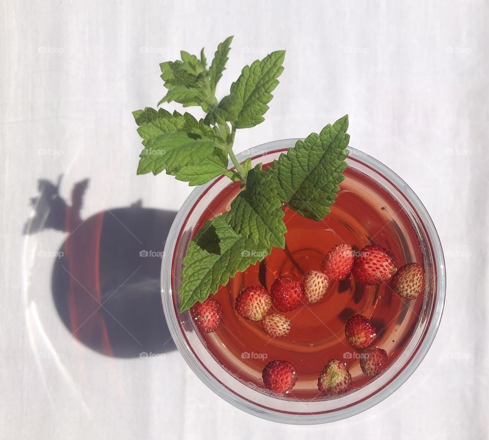Summer drink with red strawberries seen from above 