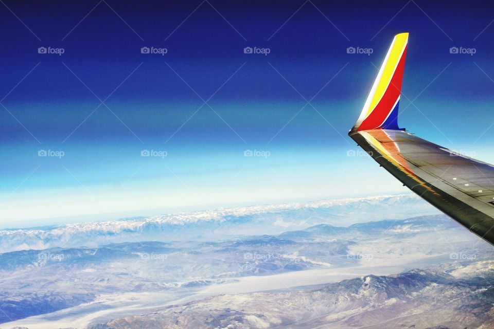 flying through the blue skies high overhead