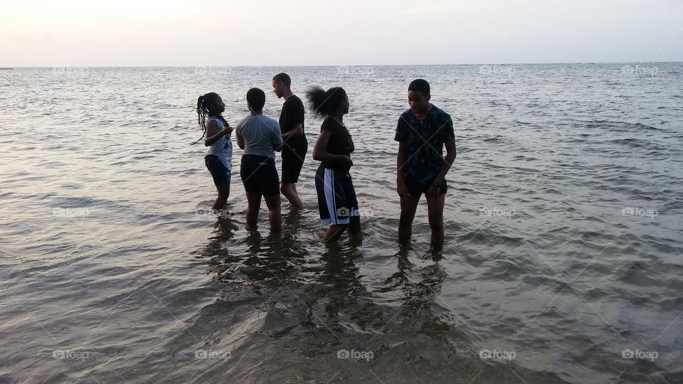 fun in the water at sunset