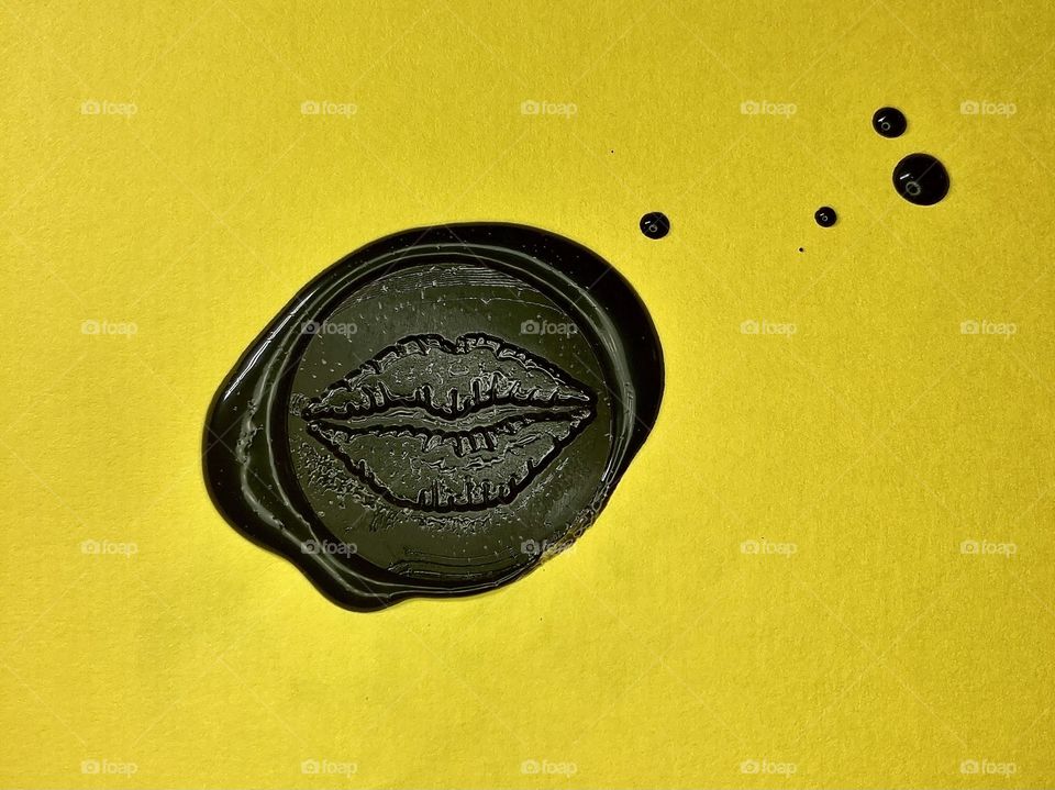 black wax seal in form of lips 