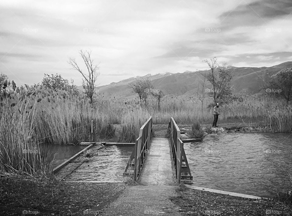 Bridge across...a bridge to get across Lake Bountiful in West Bountiful, UT.  Black and white brings out the detail in the scene. 