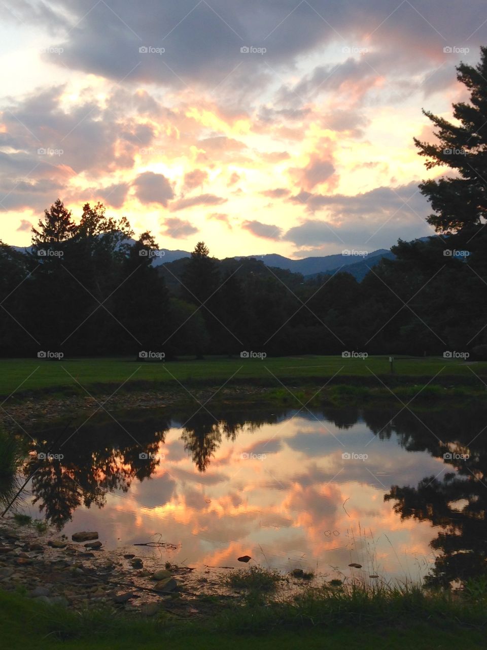 Dramatic sky reflecting on pond