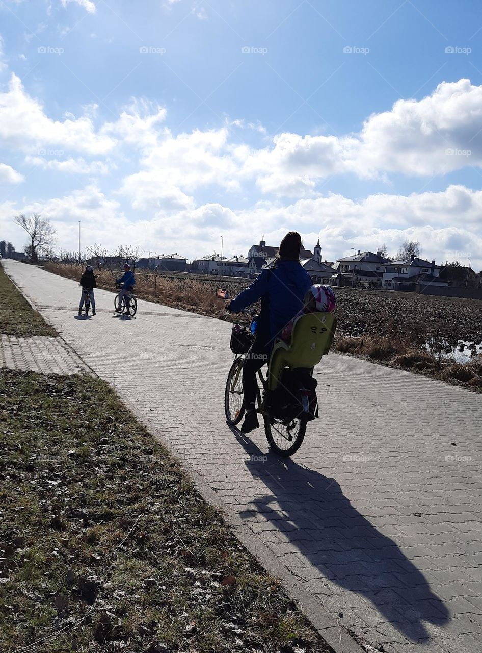 family riding bicycle in countryside