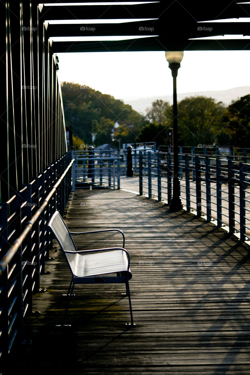 Empty bench over bridge