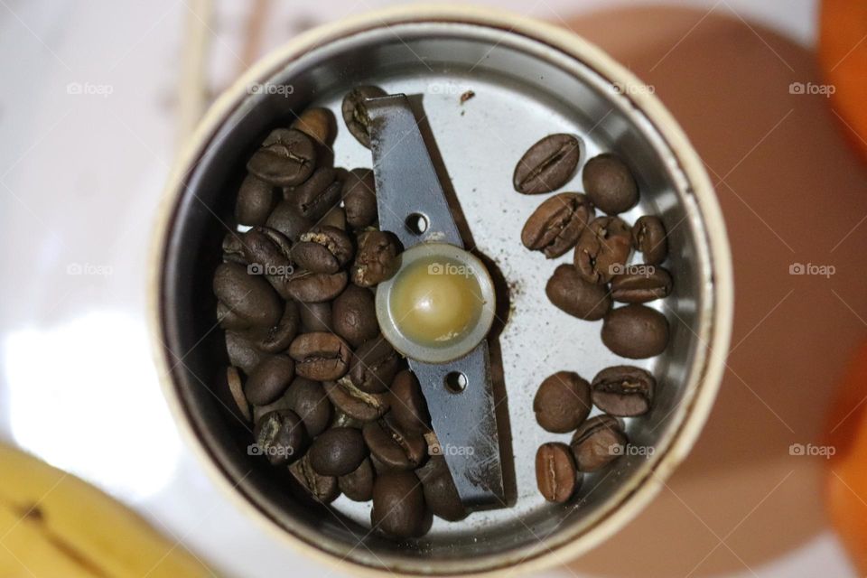 coffee beans in a coffee grinder