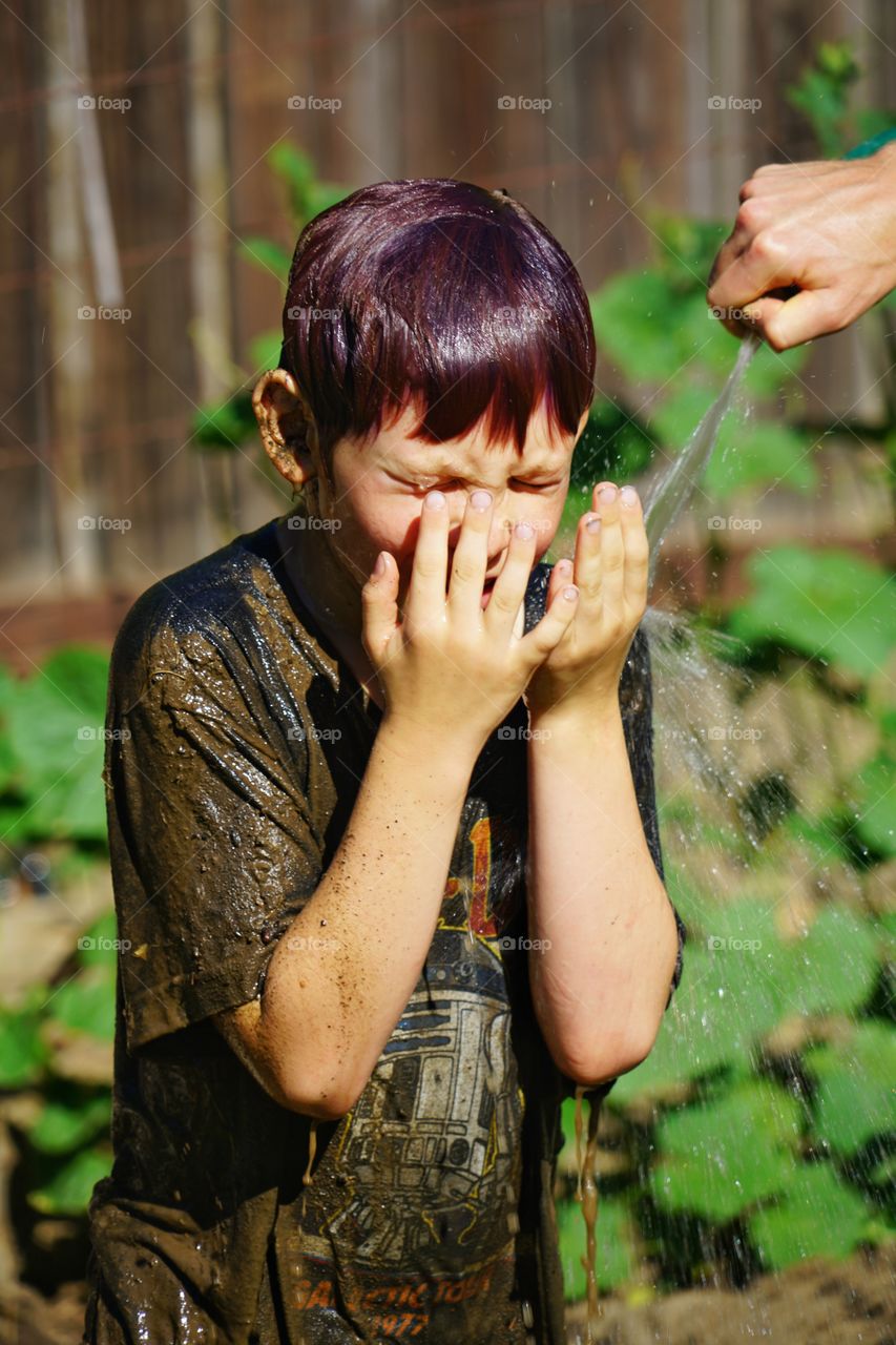 Boy Splashing Water On His Face