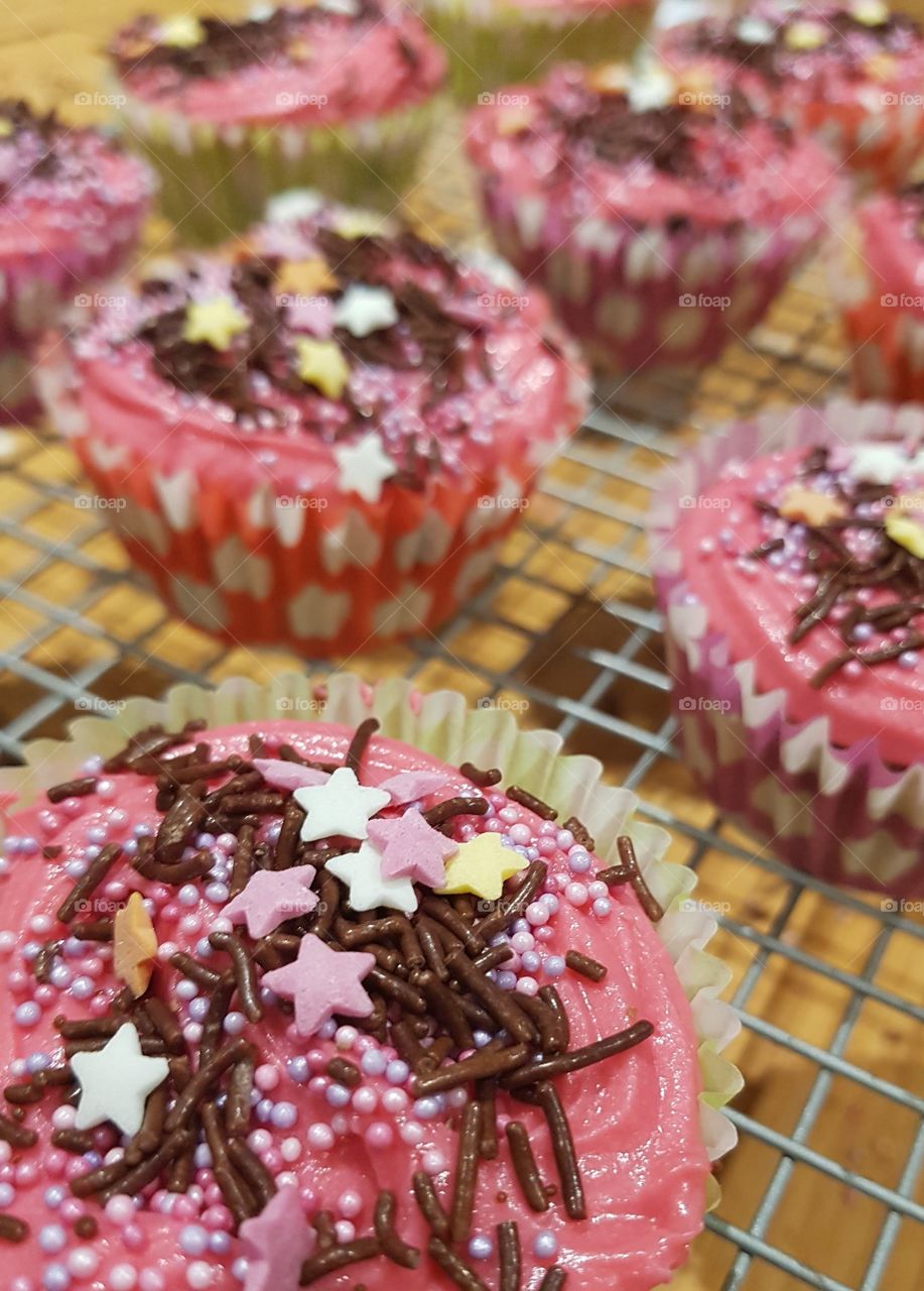 pink cupcakes with stars and sprinkles