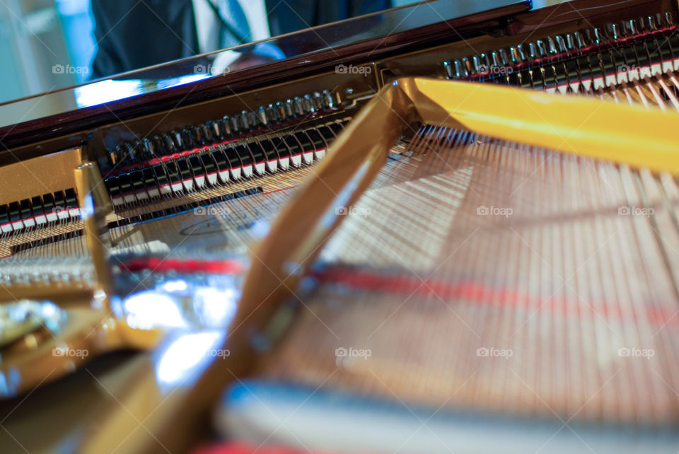 Interior of a piano and a view of its player