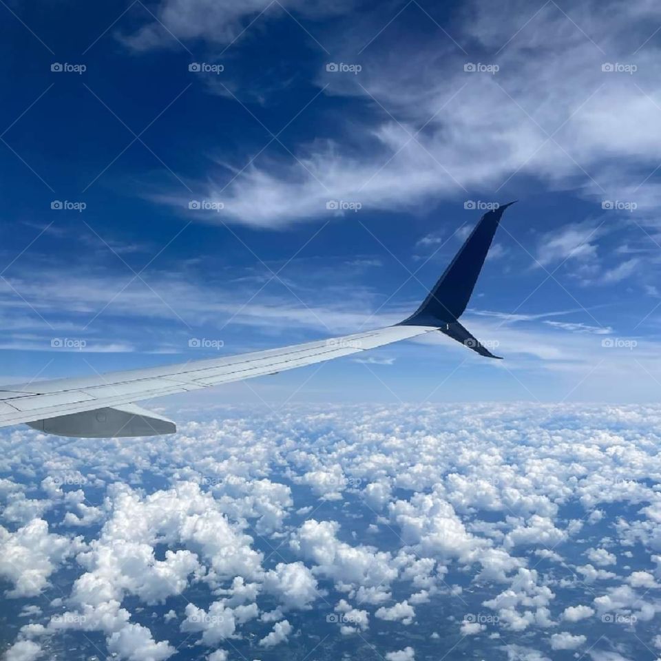 airplane wind cutting through blue sky