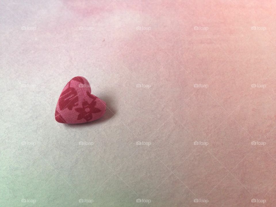 One heart button on watercolor background 