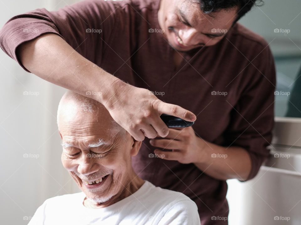Grandfather having his routine haircut