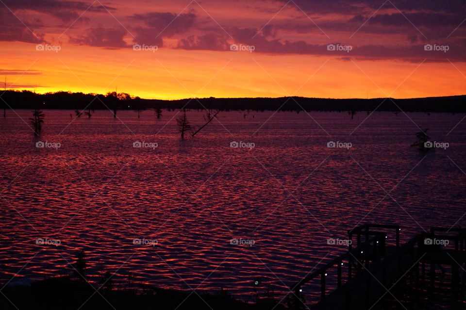 Sunrise over the lake. Orange colored Sky