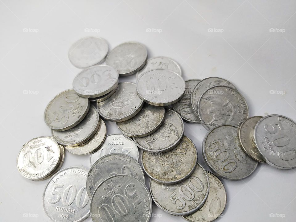 Collection of Indonesian rupiah coins on a white background