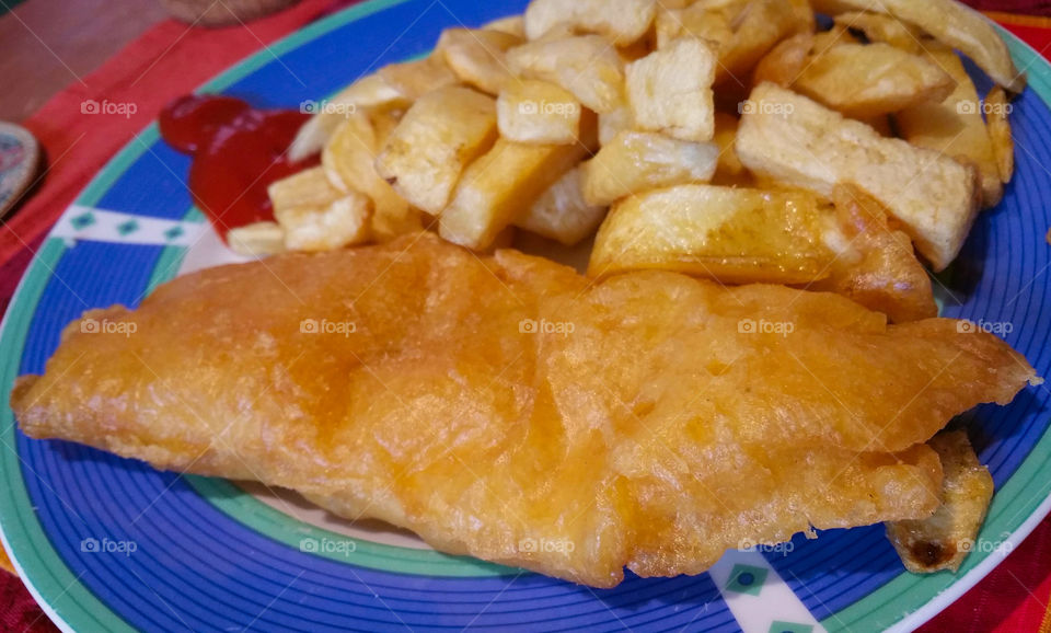 British fish and chips on a blue plate