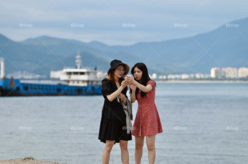 Two sisters taking selfi on their Phone 