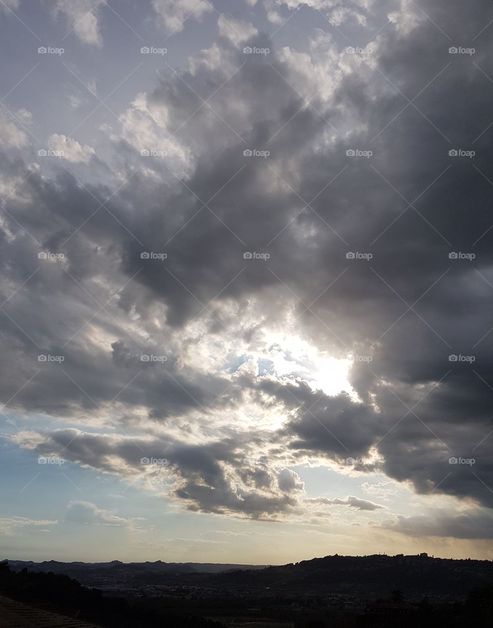 Dramatic cloudy sky over the hills at sunset