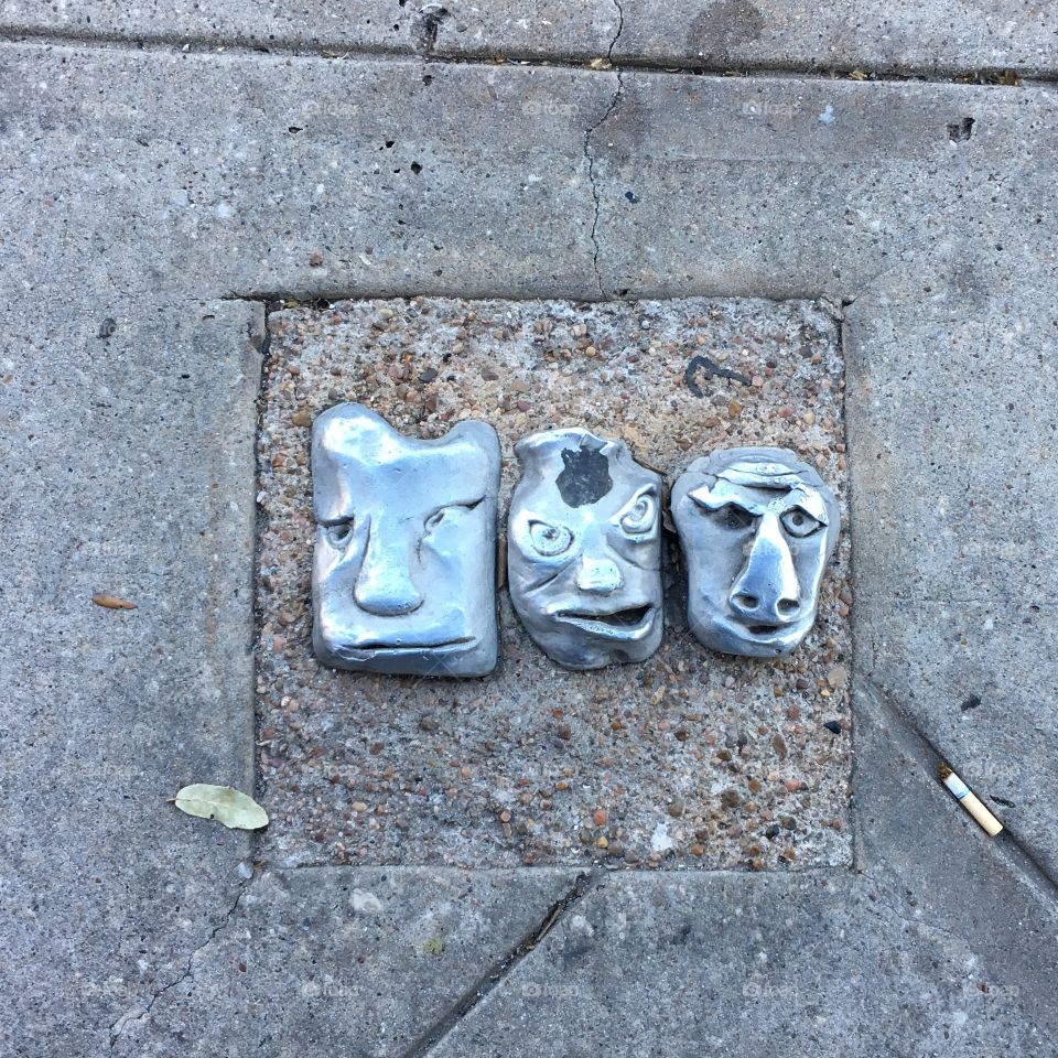 Street art in Houston Texas
Sculpted metal faces in the sidewalk downtown