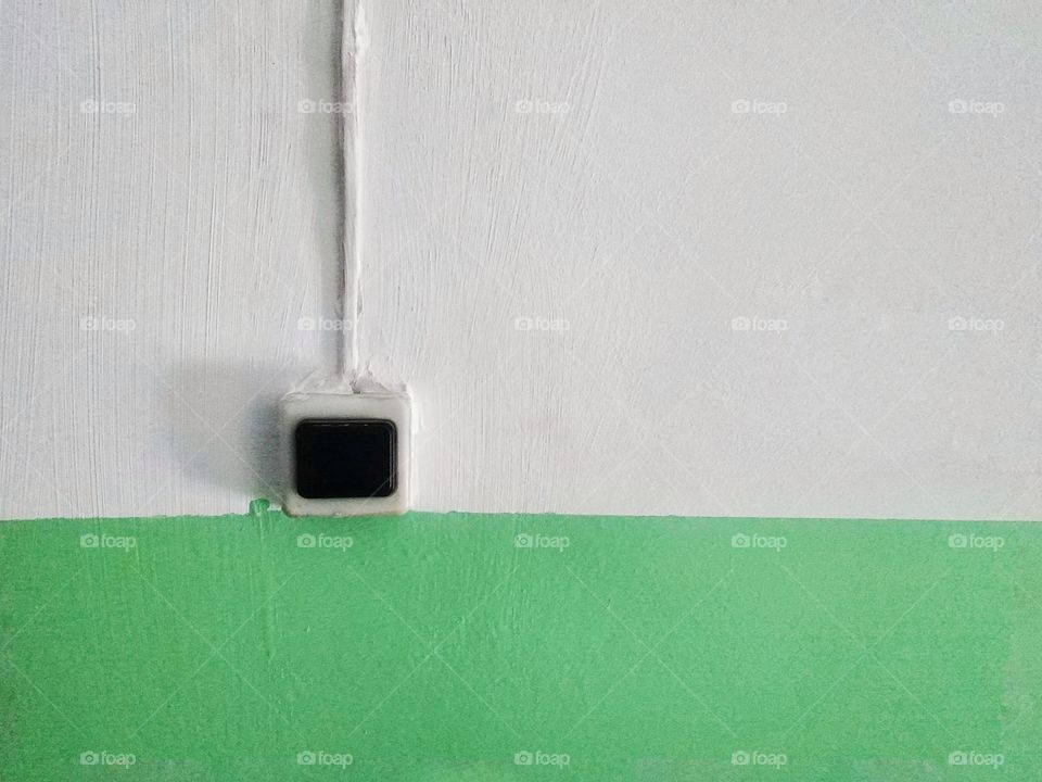 electric bell button in front of the apartment door at the entrance