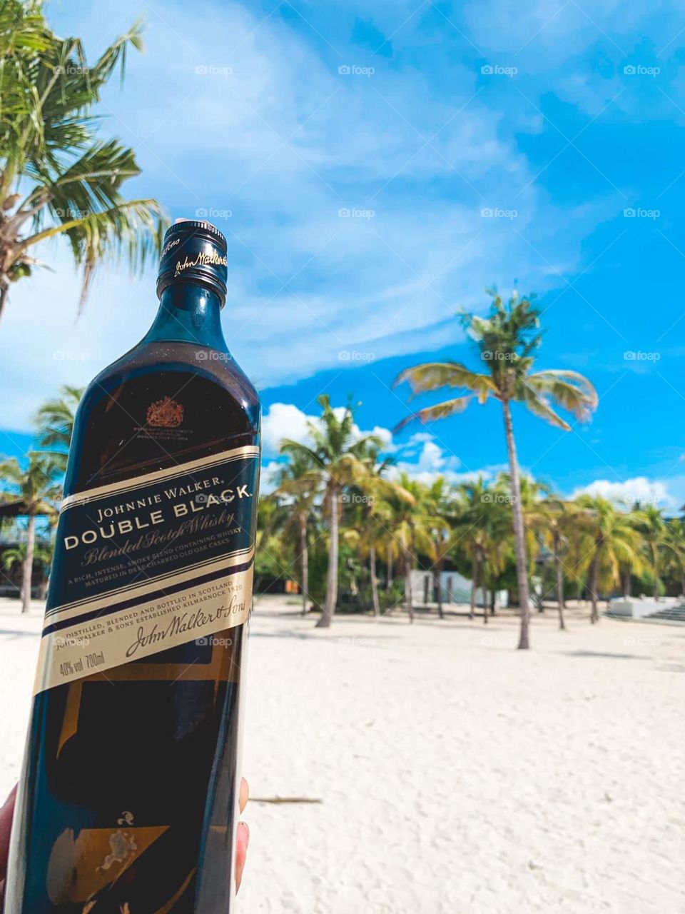 A bottle of drink on the sandy beach