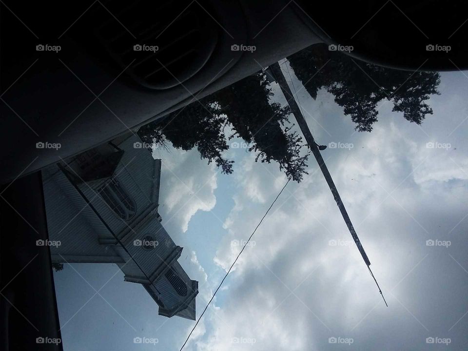 upside down clouds,blue,white,trees,pole