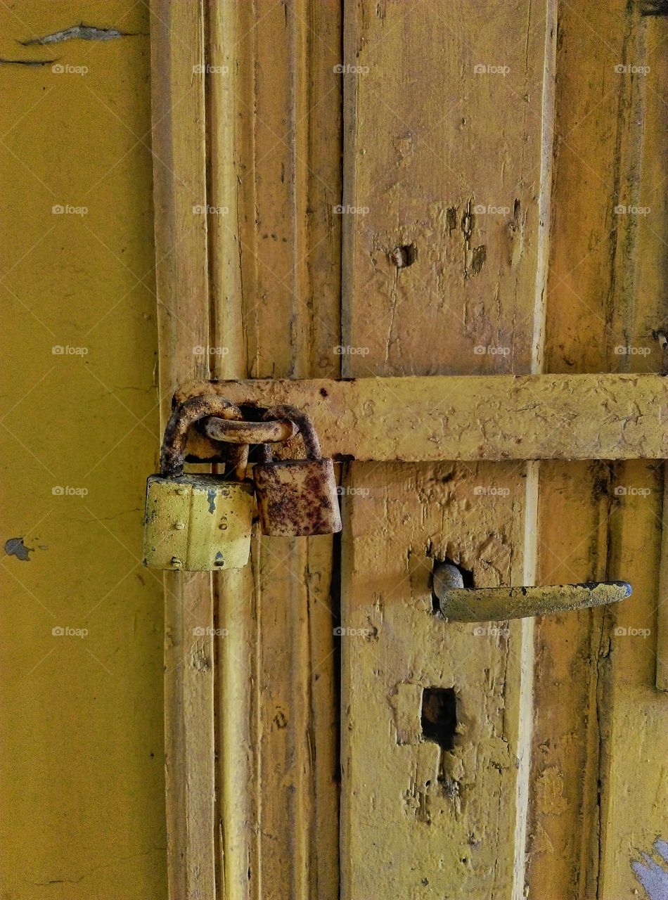 Old yellow doors with padlock
