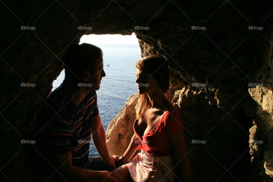 Couple sitting near sea
