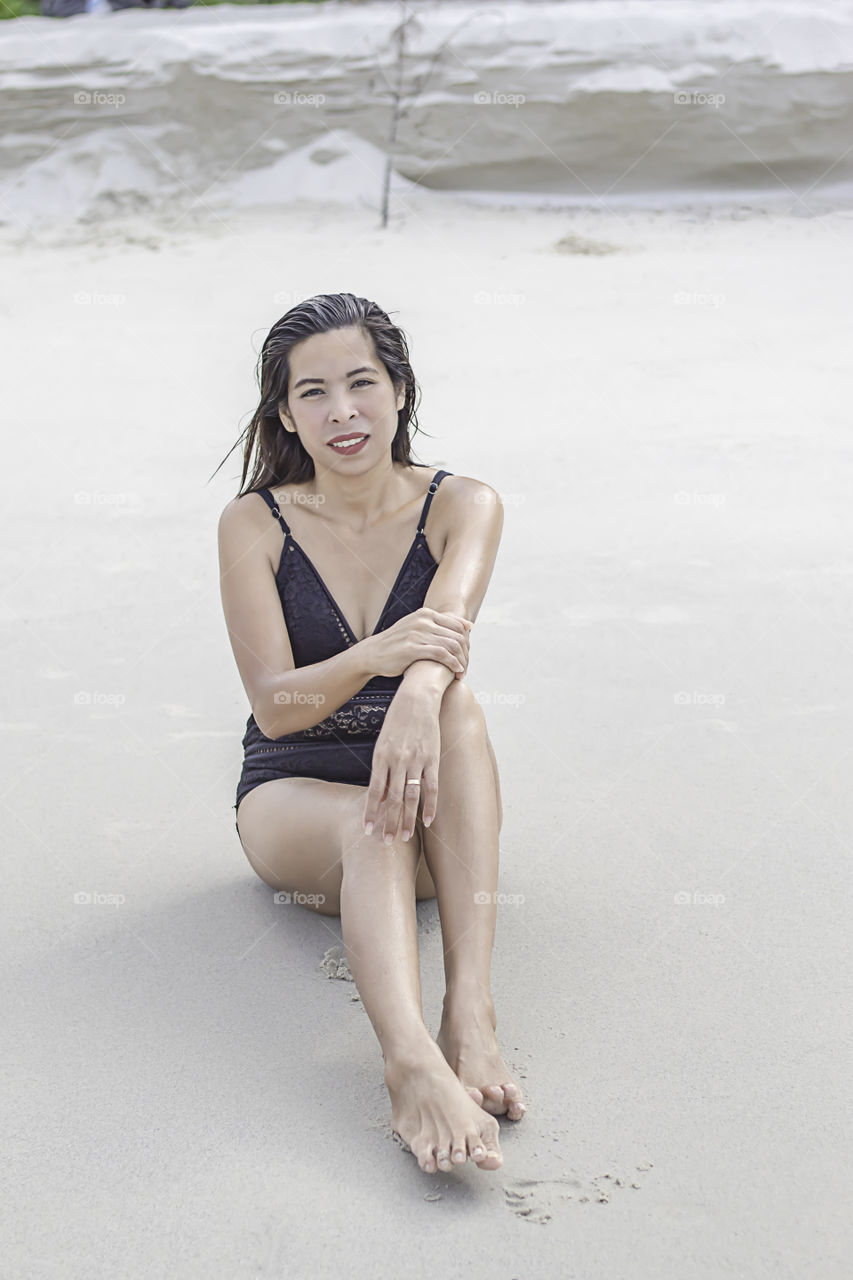 Portrait of Asian woman wearing a swimsuit on the beach.