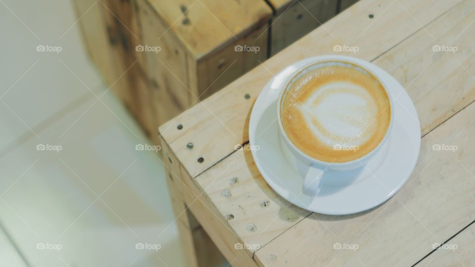 Overhead view of a coffee cup on table