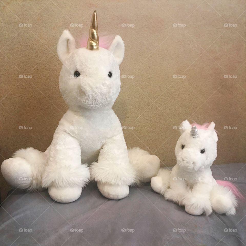 Unicorns with fuzzy pink hair and gold horn 