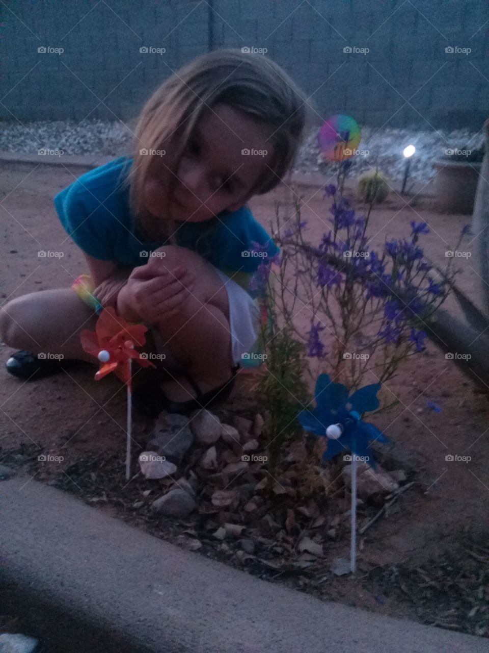 My dear, sweet, baby Granddaughter.   She is so Loving.
She loves animals, nature, people
And Jesus!! I am so grateful, 
To be Her Gamma she calls me
Because I told her not to put
The word Grand before any 
Name she would call me, 
Because it reminds me of 
A Grand Father Clock. I am 
Older but I am not that Old.
Ya Know ?? Anyway, she is 
Next to the plant she Nurtured.
Watered and even she would 
Actually Pet the plant and talk
To it as well.   That is why, I 
Could not resist talking this 
Picture of my baby Granddaughter.