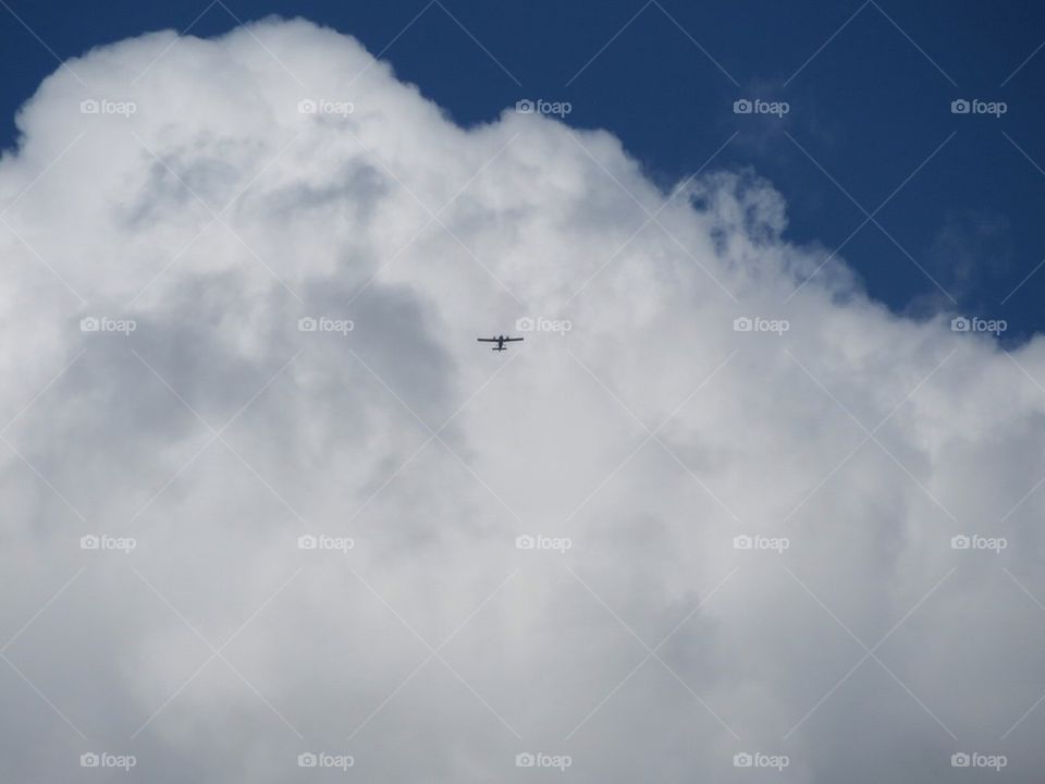 Airplane in front of a cloud