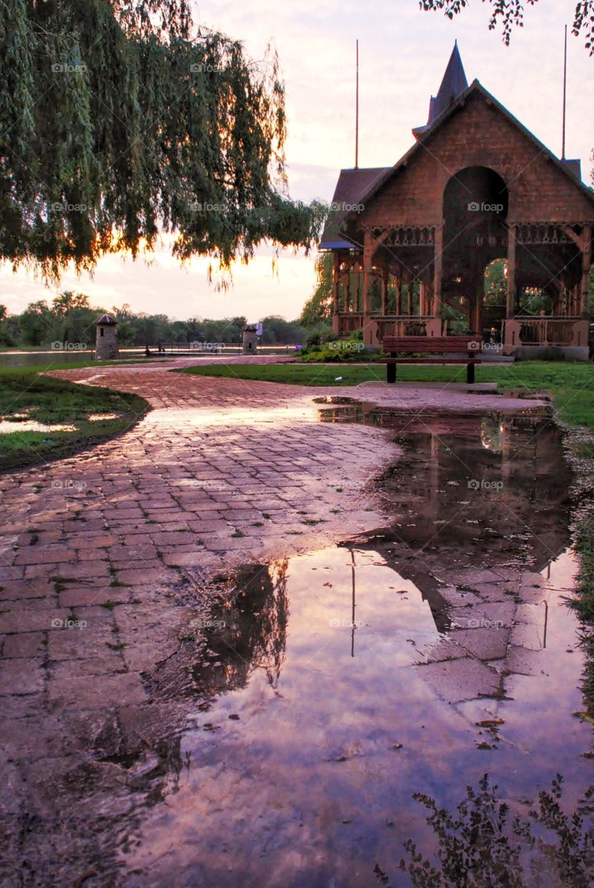 Sunset puddle . Puddle reflects The sunset near the river