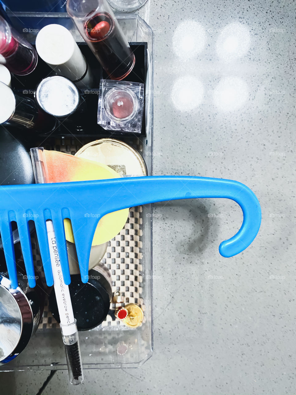 Blue comb with cosmetics 