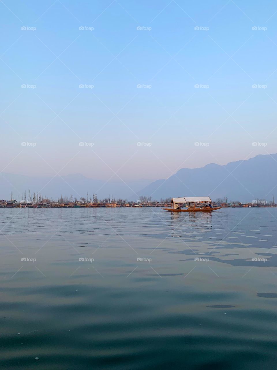 Beautiful winter landscape shot of a shikara boat in Kashmir