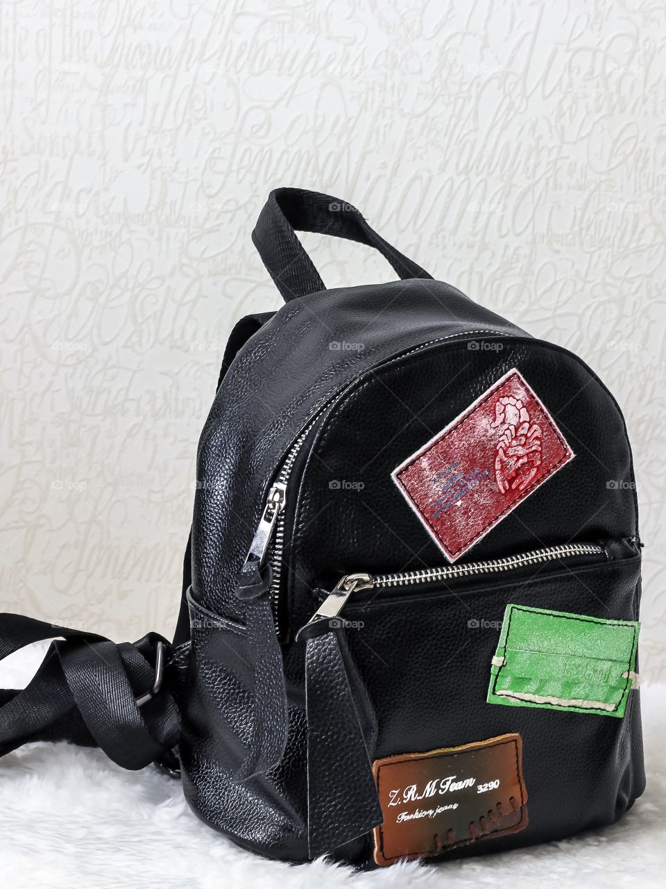 Woman's stylish backpack in black color with patches 