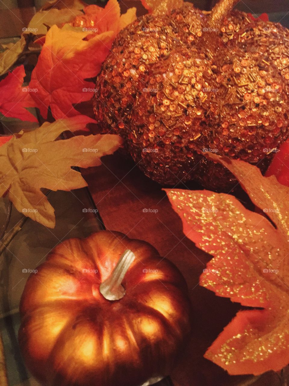 Golden pumpkin with autumn leaf