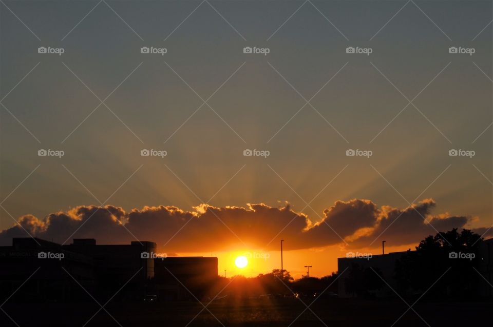Sunset and rays over a hospital 