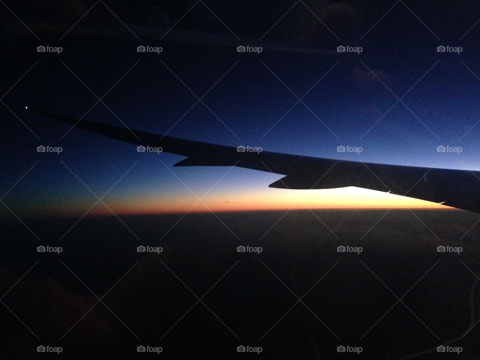 outline of a plane wing over the sunset  