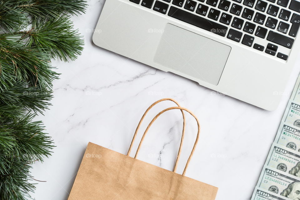 Holiday shopping. Flatlay items. Laptop, bag, Christmas tree 