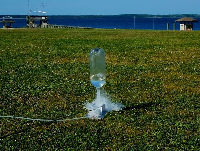 A water bottle rocket in mid launch as to blasts way up into the sky in Arapahoe North Carolina.
