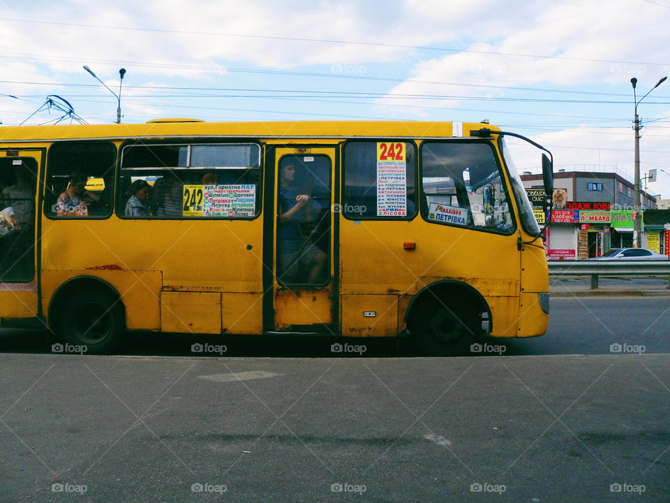 old yellow minibus is at a stop, the city of Kiev